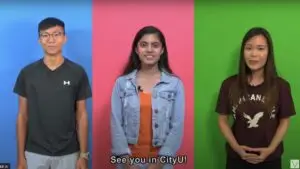 Three individuals stand side by side against colored backgrounds—blue, pink, and green. They smile and appear to be addressing the viewers in what looks like a video shooting set. The caption at the bottom reads, "See you in CityU!".