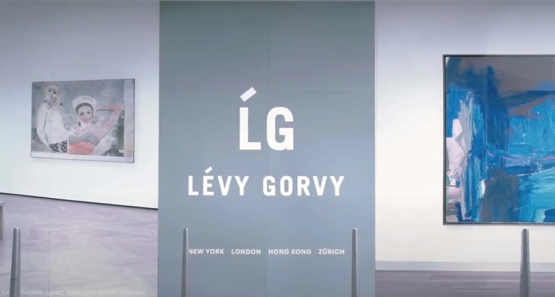 Inside the art gallery, a large grey divider displays "LG LÉVY GORVY" with the cities "New York," "London," "Hong Kong," and "Zurich" listed below. To the left, a painting graces the wall. The space is primed for an elegant promotional video highlighting fine art.