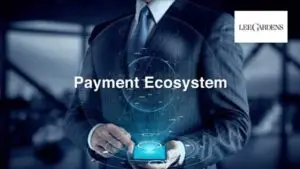 A person in a suit is holding a smartphone with an animated digital hologram emerging from it, symbolizing technology and innovation. The text "Payment Ecosystem" is prominently displayed, and the logo "LEGARDENS" is visible in the top right corner against a blurred background.
