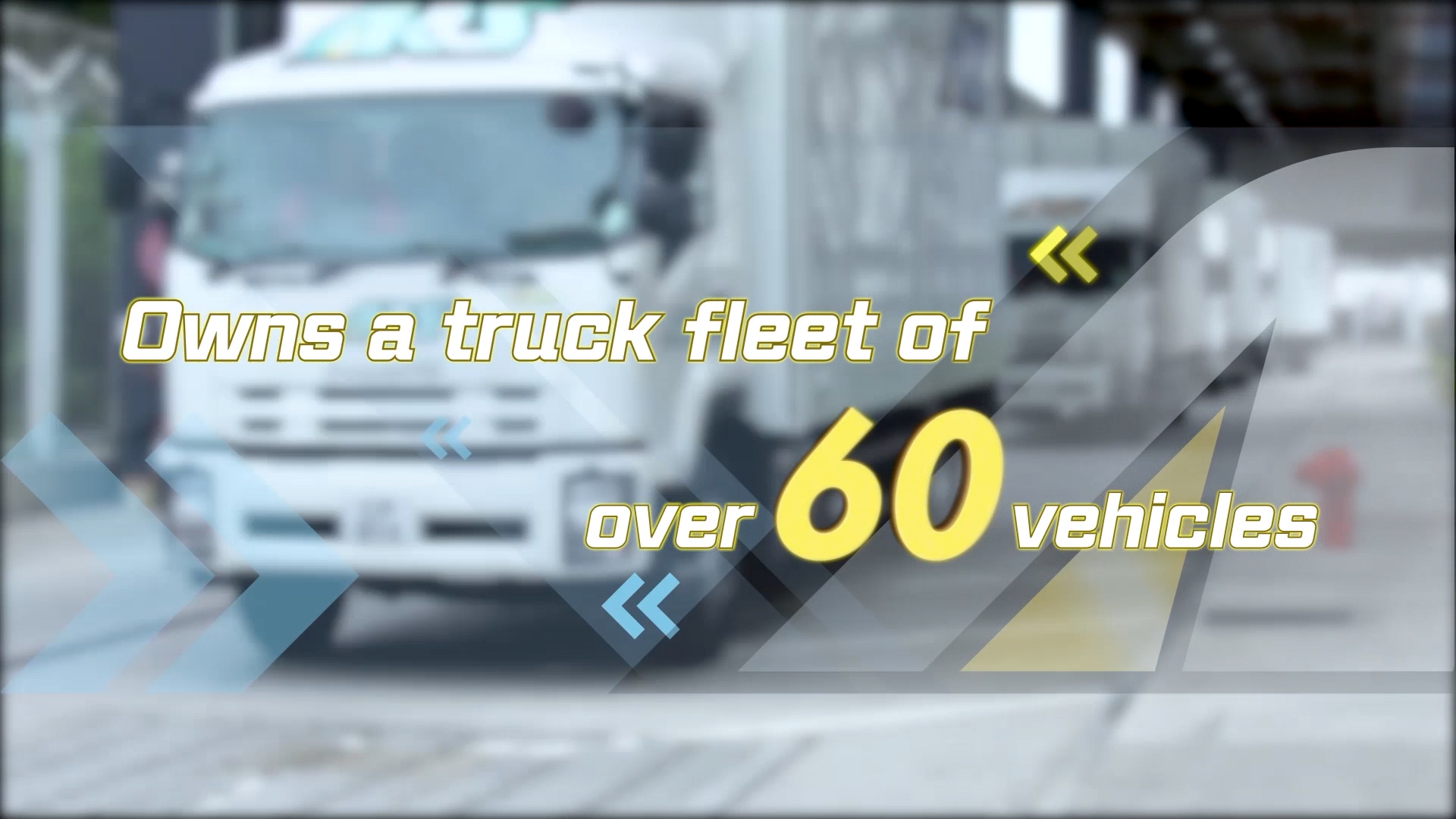 A blurred image of a white truck with text overlay that reads: "Owns a truck fleet of over 60 vehicles.