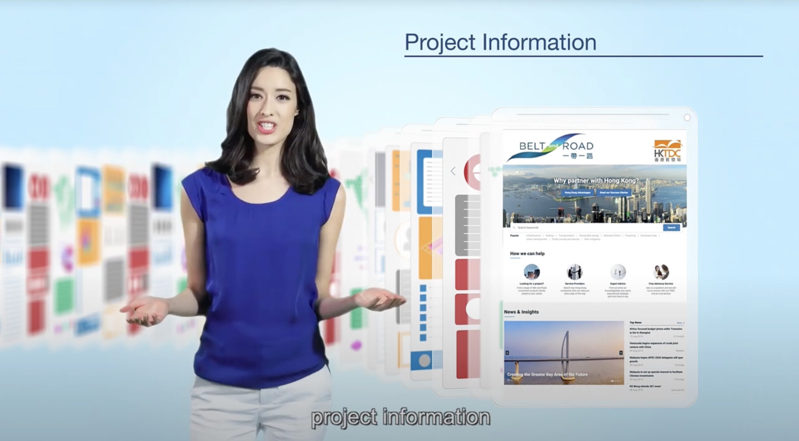 A woman in a blue top stands in front of a display of digital project webpages, with the heading "Project Information" at the top right. She gestures with her hands, and text at the bottom reads "project information.