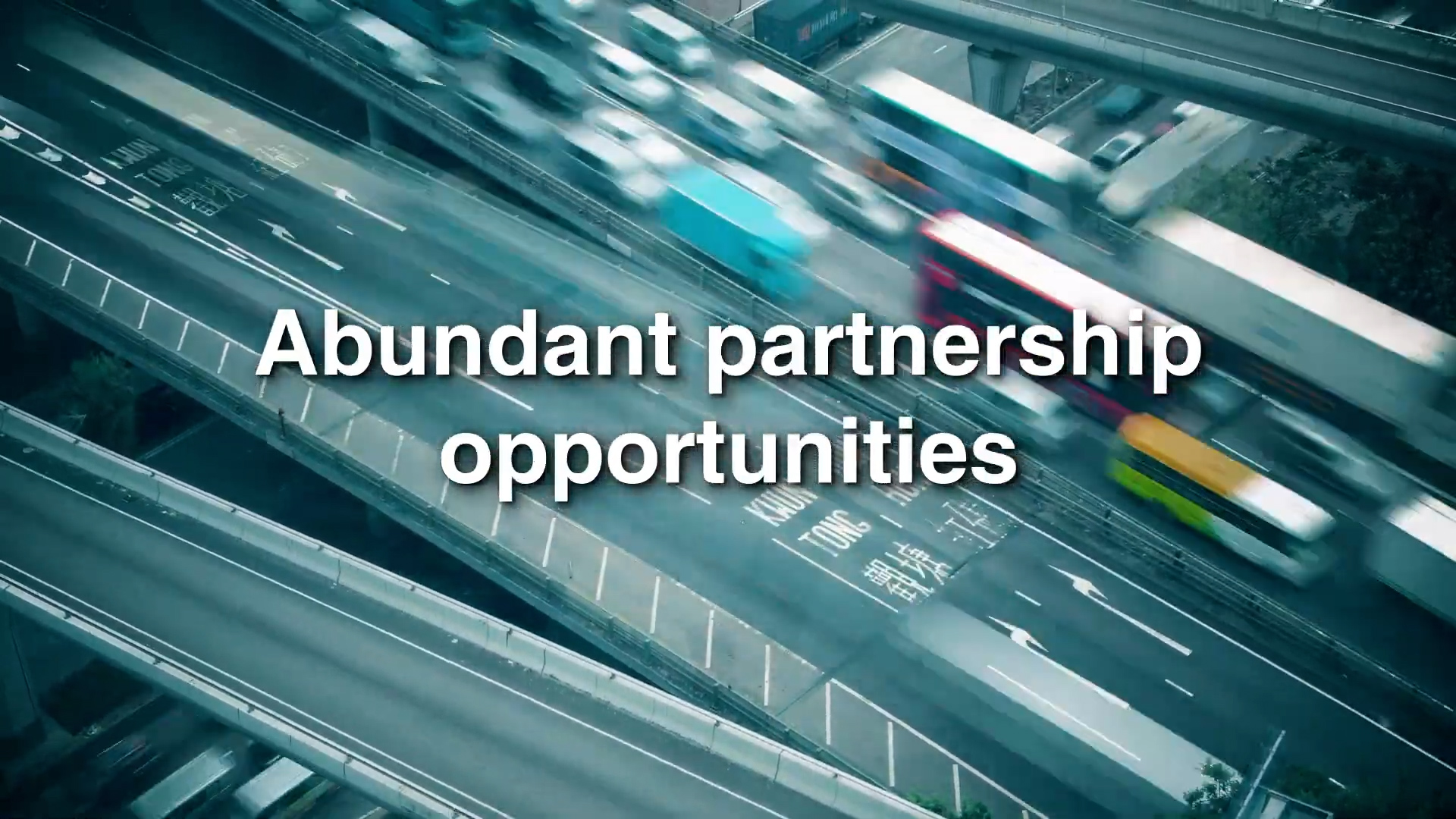 A blurred, aerial view of busy city highways with cars and buses, overlaid with the text "Abundant partnership opportunities" in large white letters.