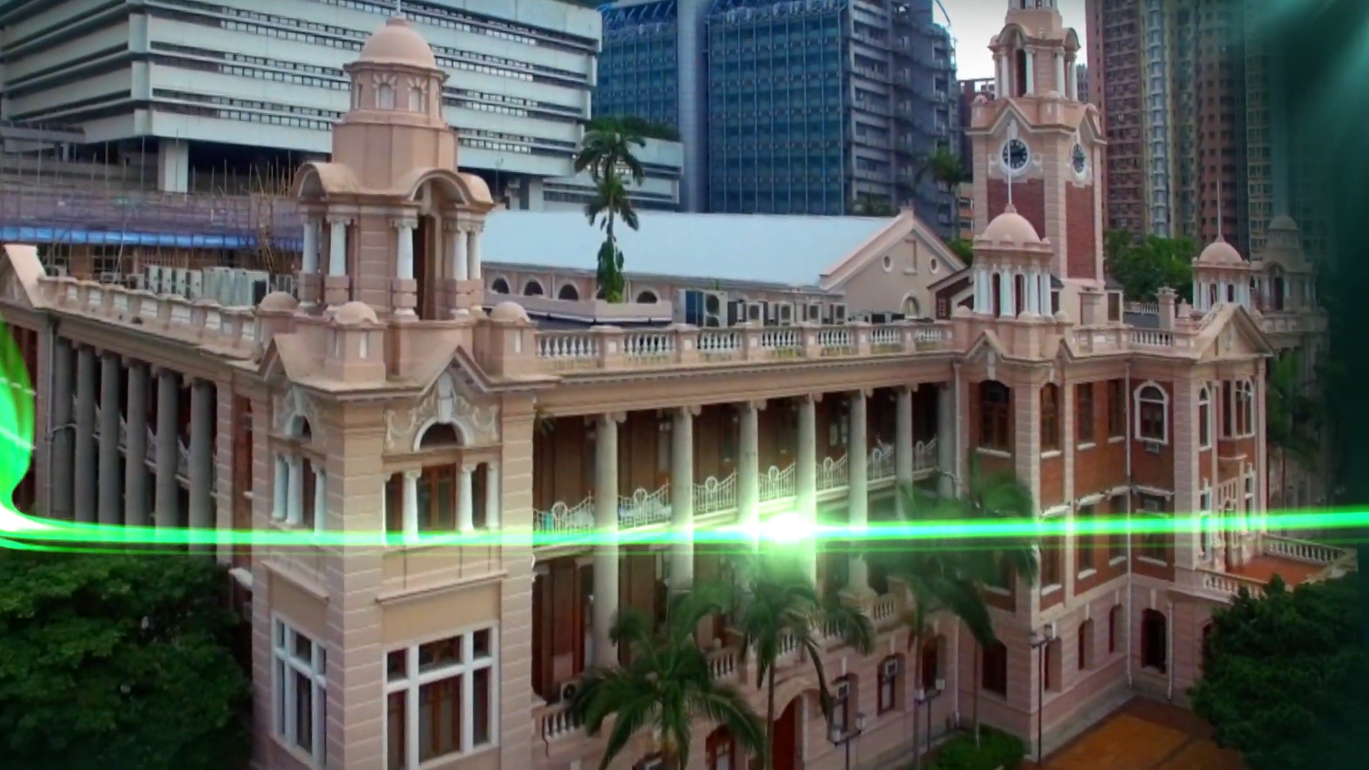 A historic, colonial-style building with columns and towers stands in front of modern high-rise buildings, with a green light streak passing across the image.