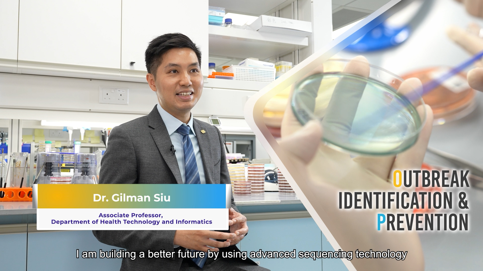 Dr. Gilman Siu stands in a laboratory, smiling while explaining. The screen shows his title and department. An inset image of a gloved hand holding a petri dish appears beside the text "OUTBREAK IDENTIFICATION & PREVENTION.