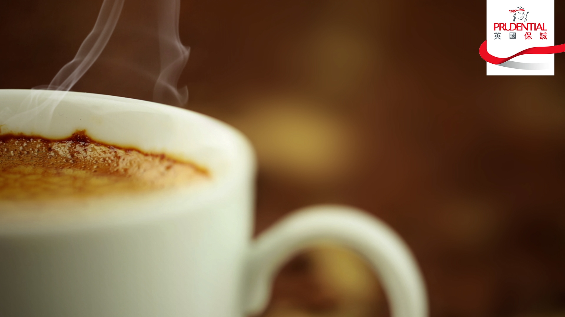 A close-up of a steaming cup of coffee in a white mug, with a blurred brown background. The Prudential logo appears in the top right corner.