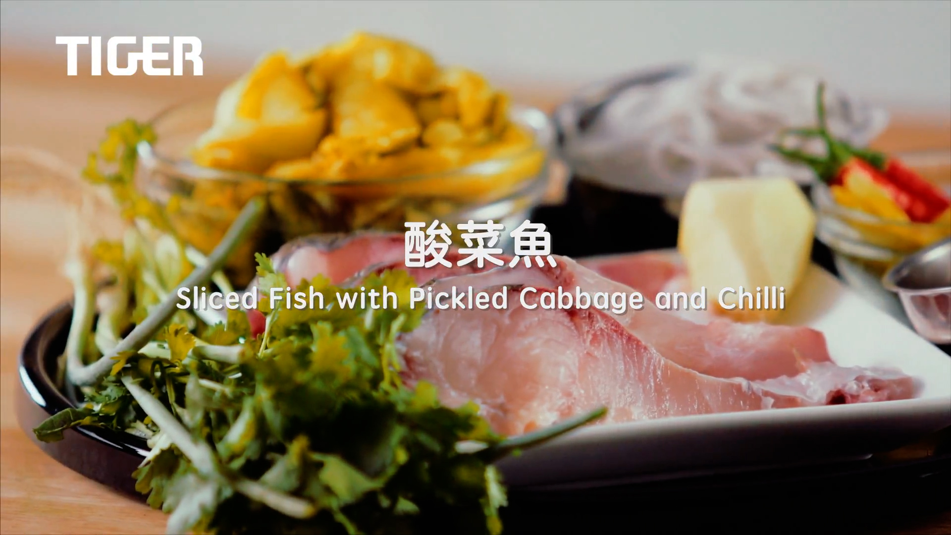 Close-up of fresh ingredients including sliced fish, herbs, pickled cabbage, and chili on a plate. The text reads: “Sliced Fish with Pickled Cabbage and Chilli” with “TIGER” brand logo in the corner.