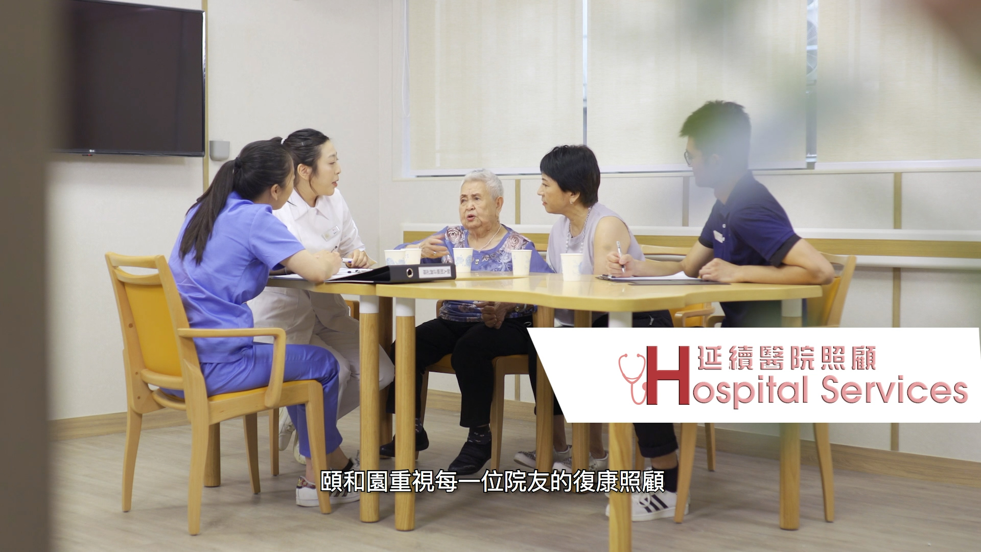 Four women, including two nurses and two patients, sit around a table in a medical office discussing paperwork. The subtitle and a "Hospital Services" logo with Chinese text are visible on the image.